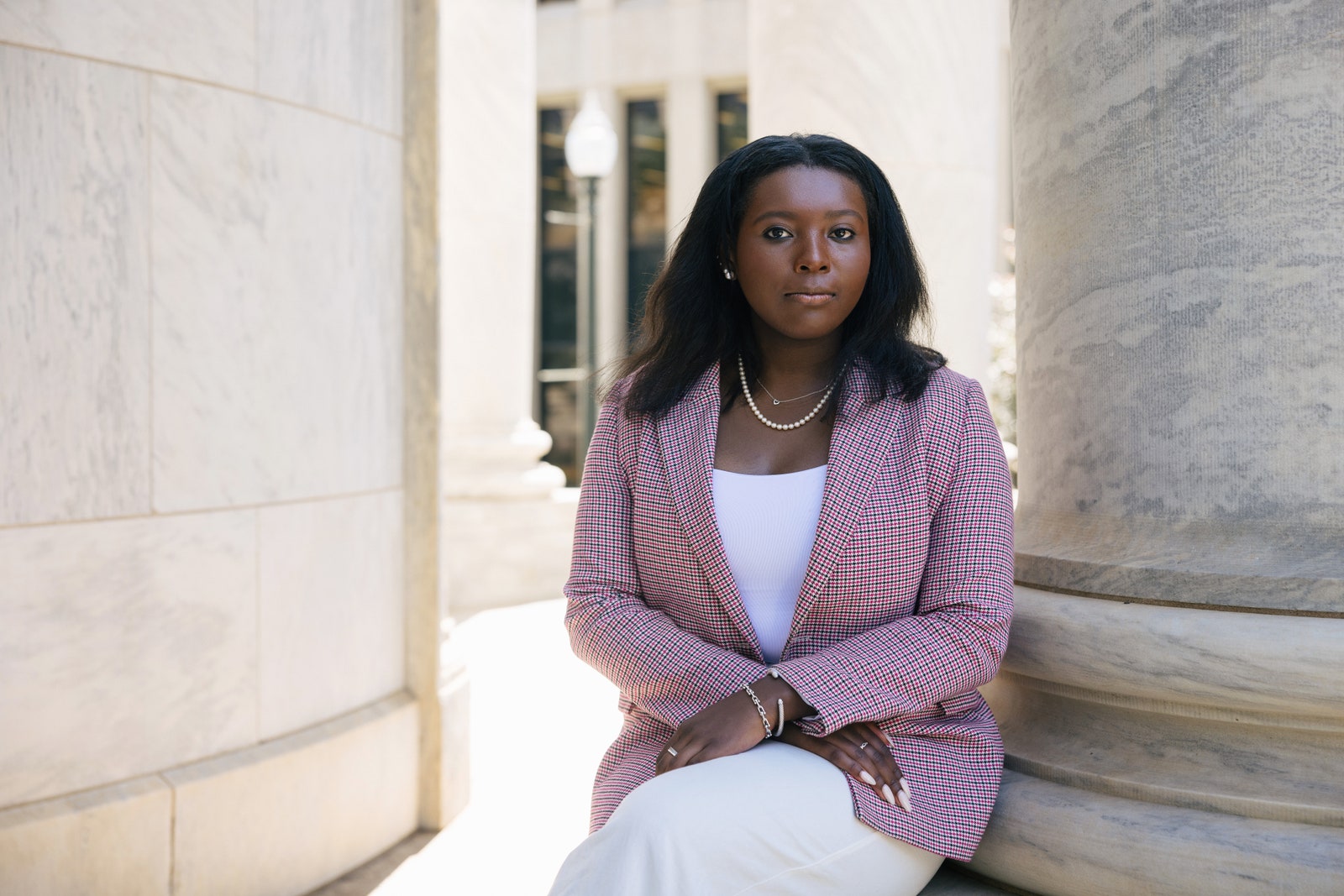 Image may contain Person Sitting Adult Accessories Bracelet Jewelry Black Hair Hair Necklace Head Face and Blazer