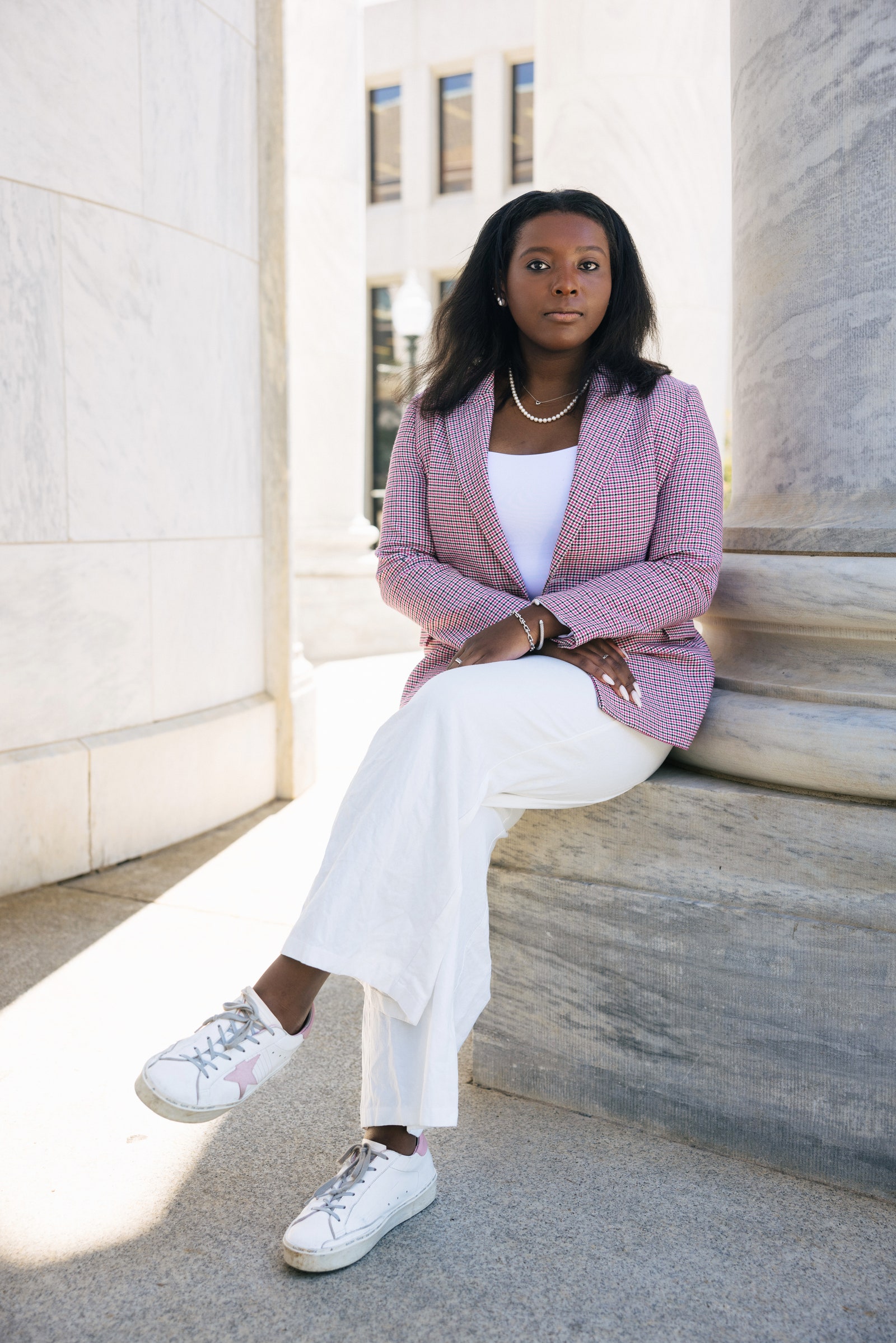 Young woman sittingwith sneakers on her college campus